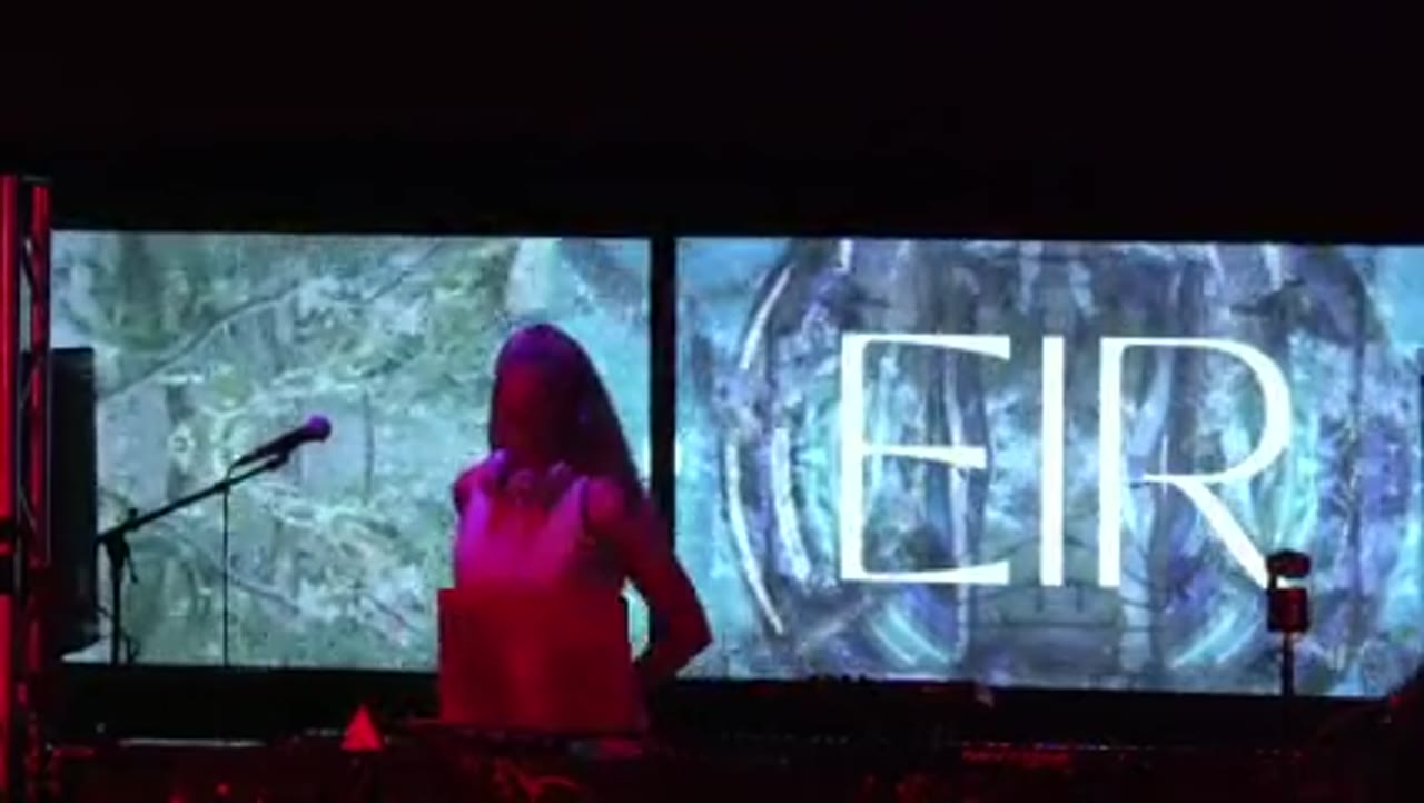 EIR at the decks between two panels of projected forest and watercolor visuals
