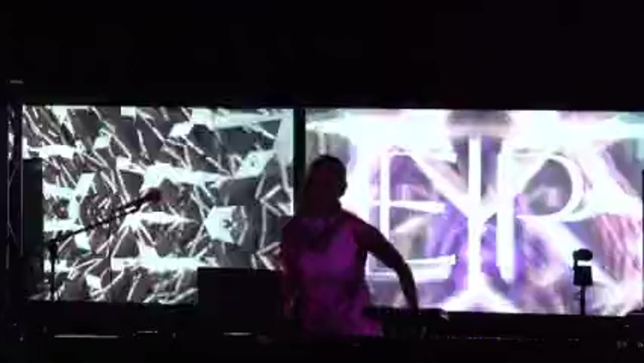 EIR silhouetted against a wall of crystalline white visuals